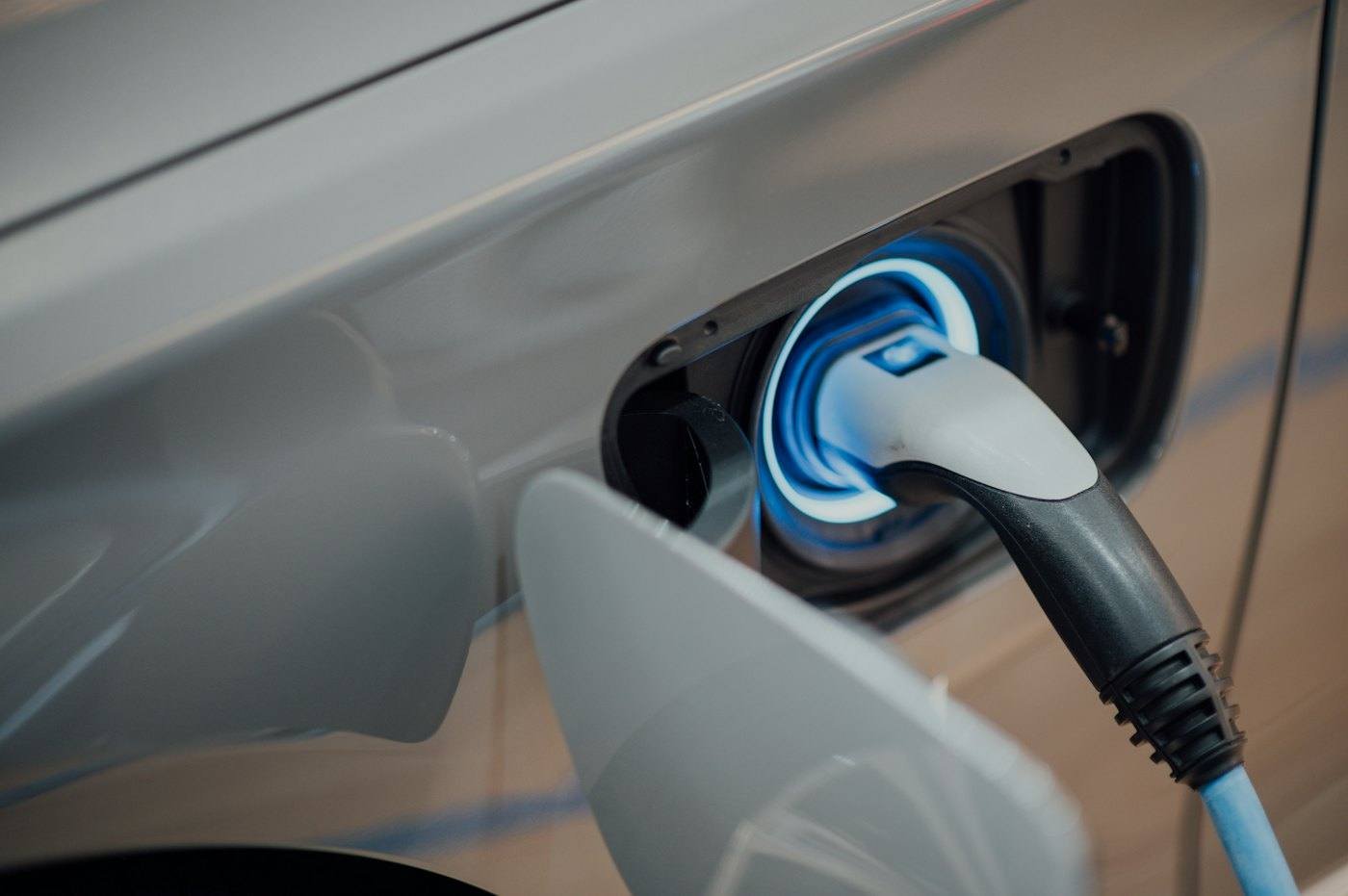 A charging cable plugged into an electric vehicle