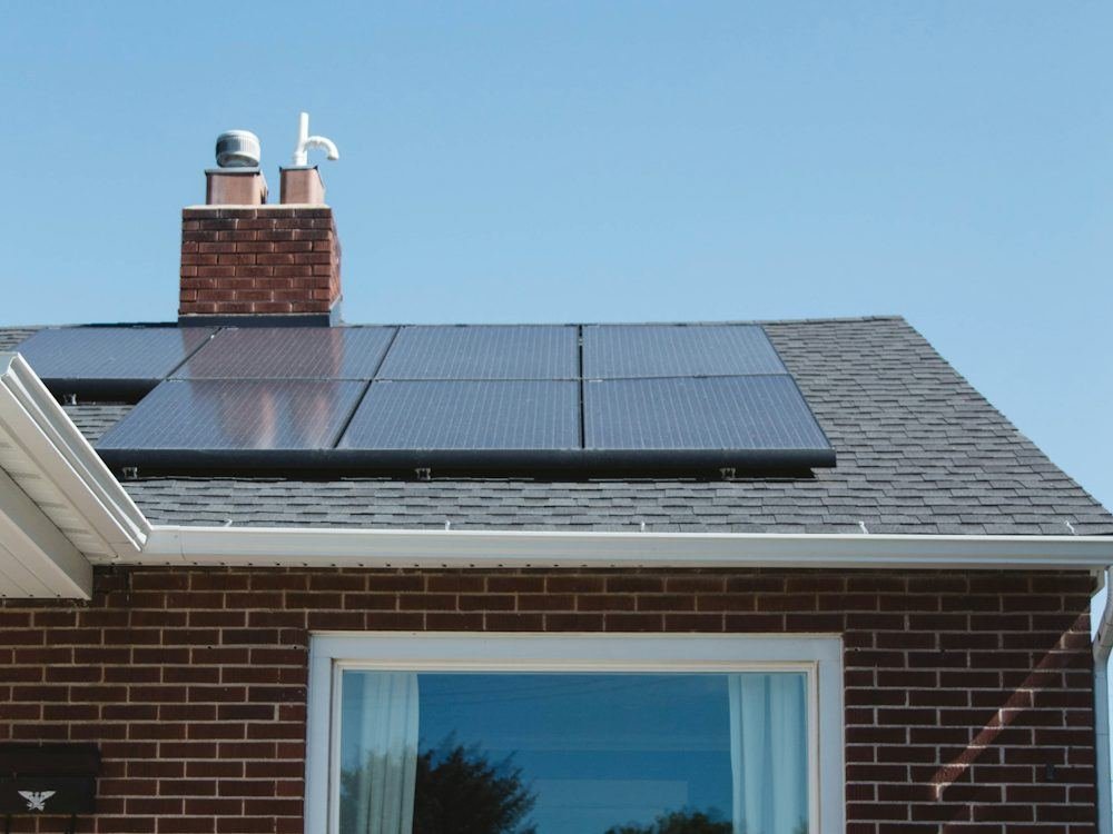 A brick house with solar panels on its roof