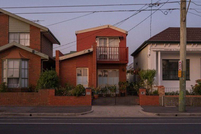 A row of brick houses on a suburban street